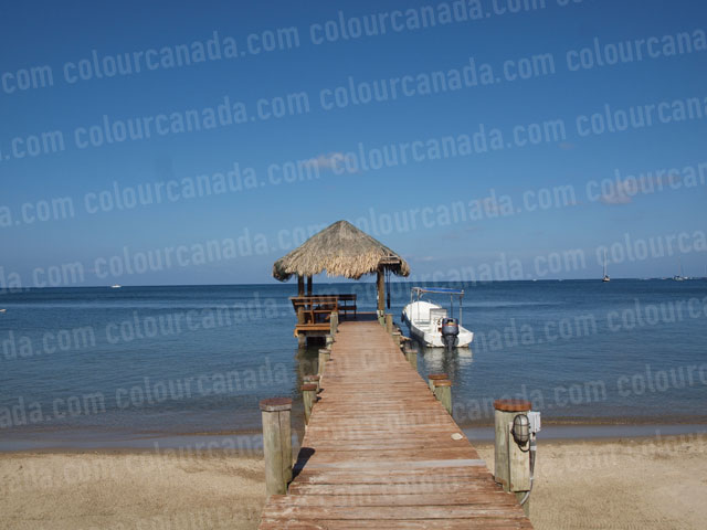 Caribbean Dock with Palapa and Boat | Cheap Stock Photo