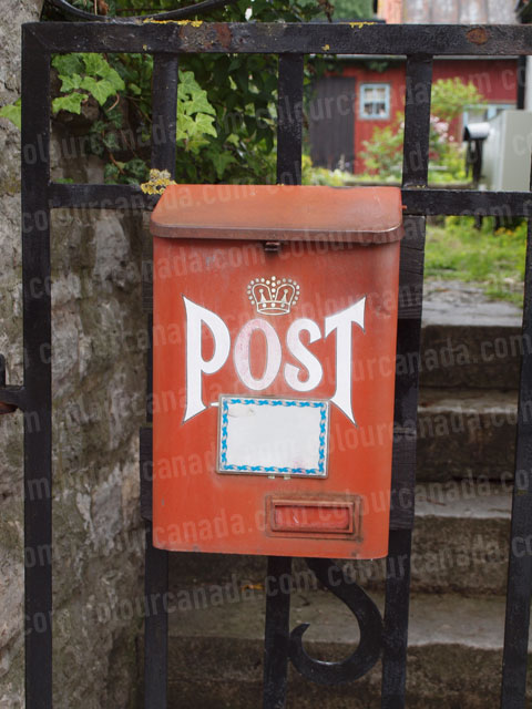 Red Post Box on a Fence | Cheap Stock Photo