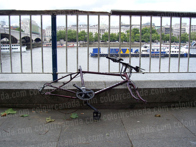 Locked Bicycle Stripped to the Frame | Cheap Stock Photo